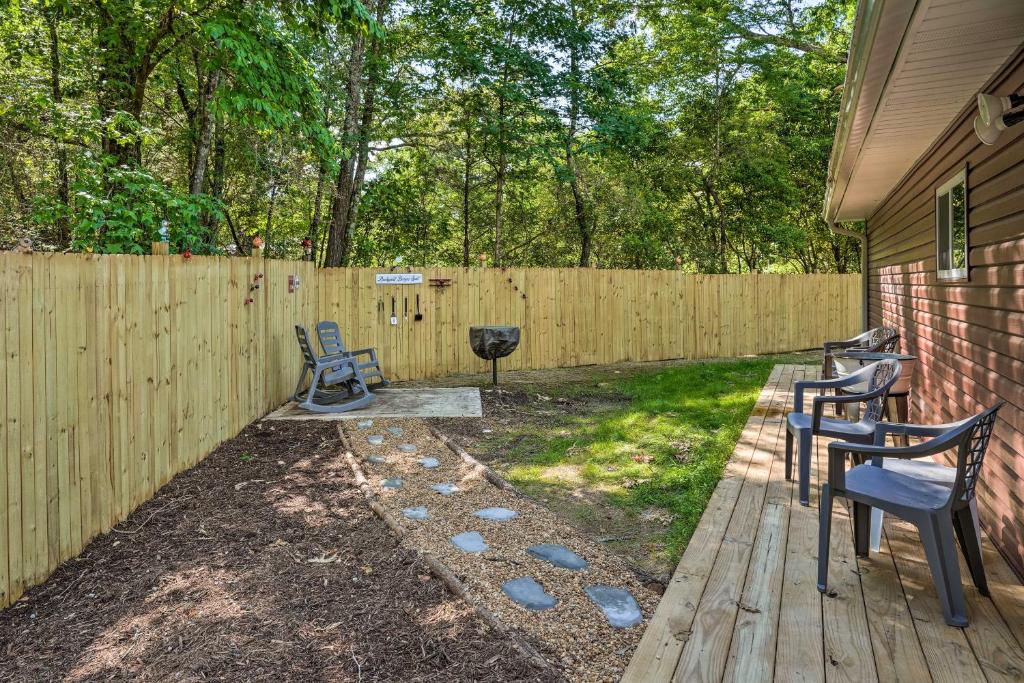 a backyard with a fence and chairs and a grill at Rock Spring Hideaway with Large Yard and Grill! in LaFayette