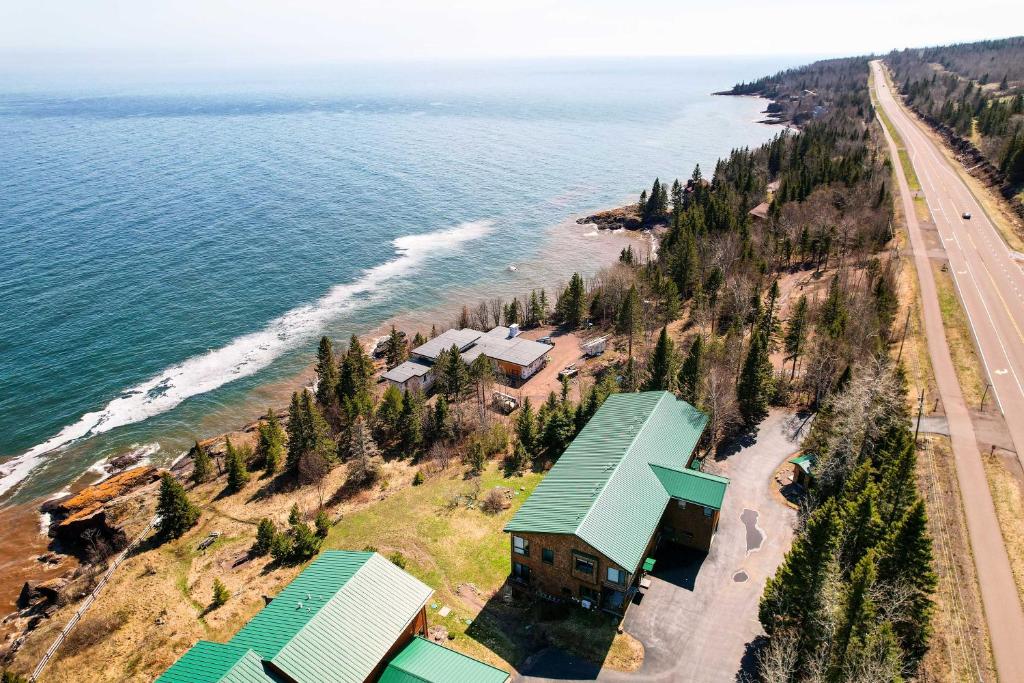 an aerial view of a house next to the ocean at Tofte Escape with Balcony and Lake Superior Views in Tofte