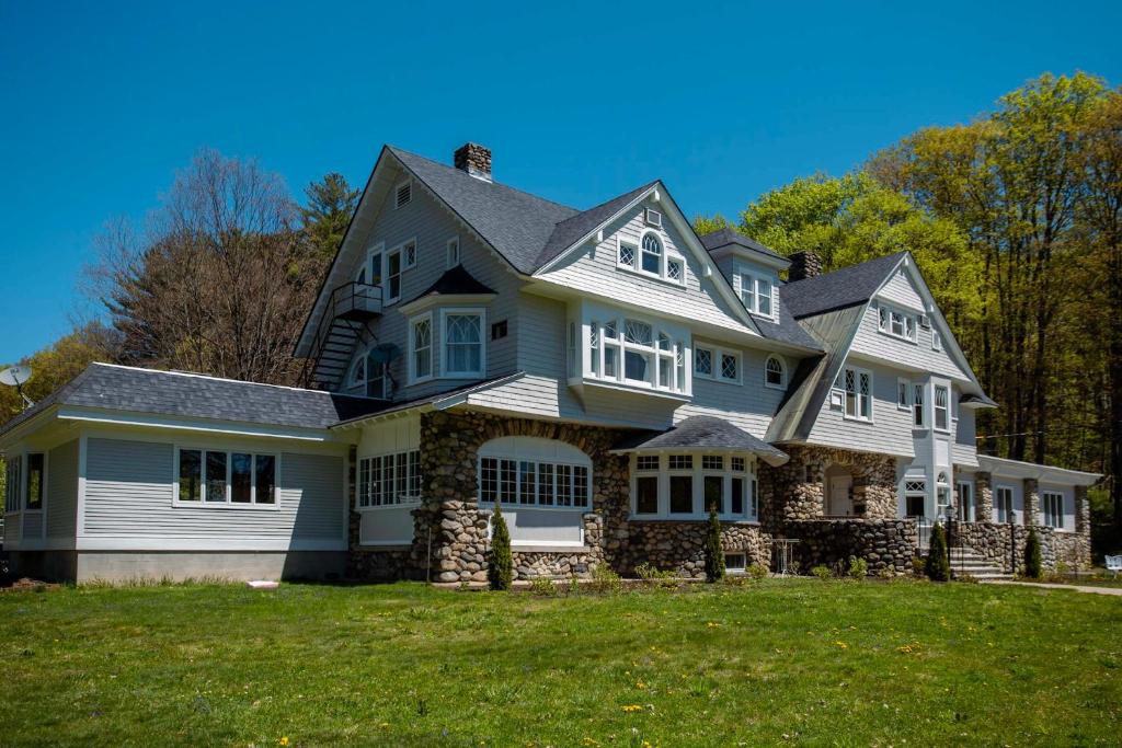 a large white house with a large yard at The Hartness House in Springfield