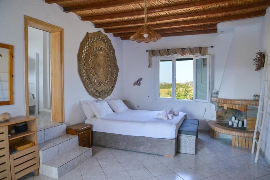 a bedroom with a large bed and a window at XALAKAS SUMMER HOUSE in Empourios