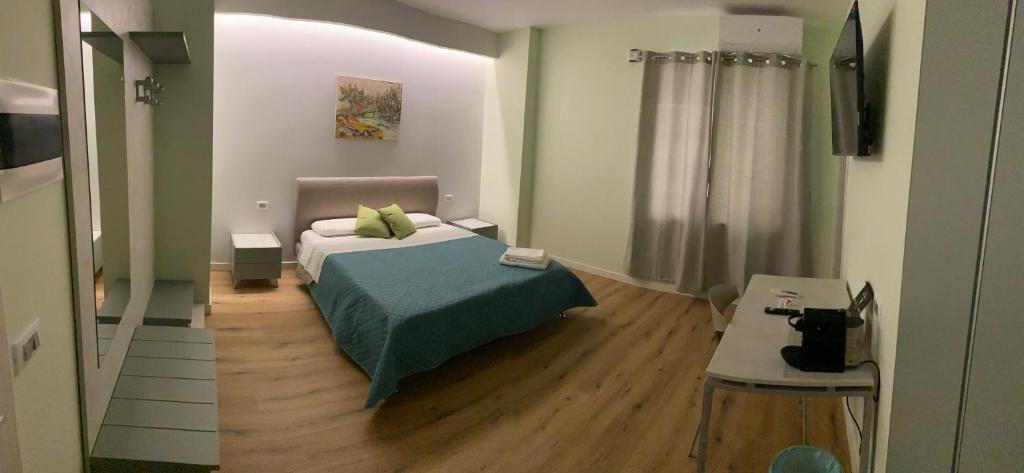 a small bedroom with a bed and a table at LA META ROOMS in Potenza