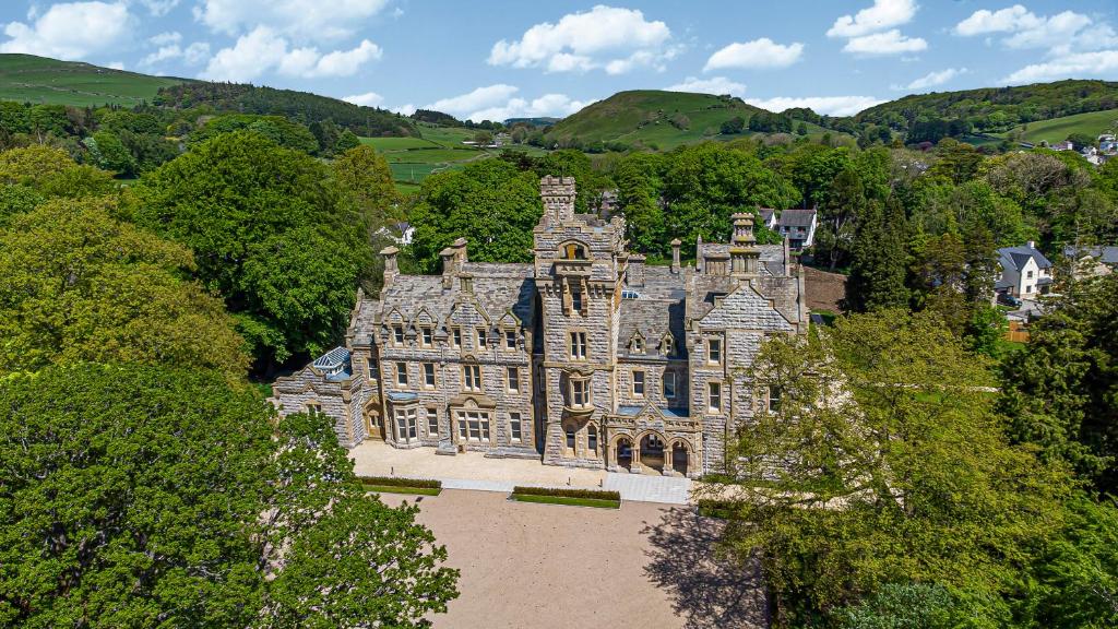 an old castle in the middle of a forest at The Emma Suite Stone Cross Mansion in Ulverston