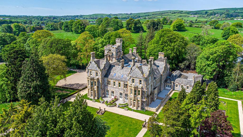 an aerial view of an old mansion with trees at The Lucy Suite Stone Cross Mansion in Ulverston