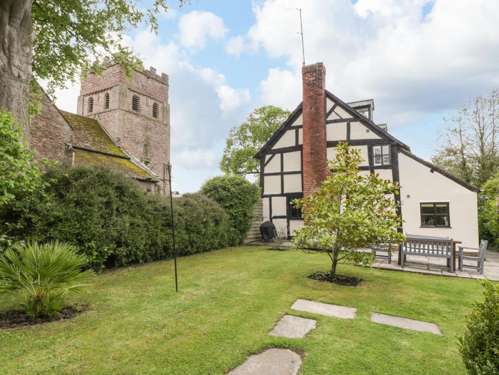 an old black and white building with a tower at Notts House in Hereford