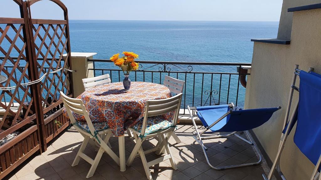 a table and chairs on a balcony with the ocean at Borgo Prino in Imperia