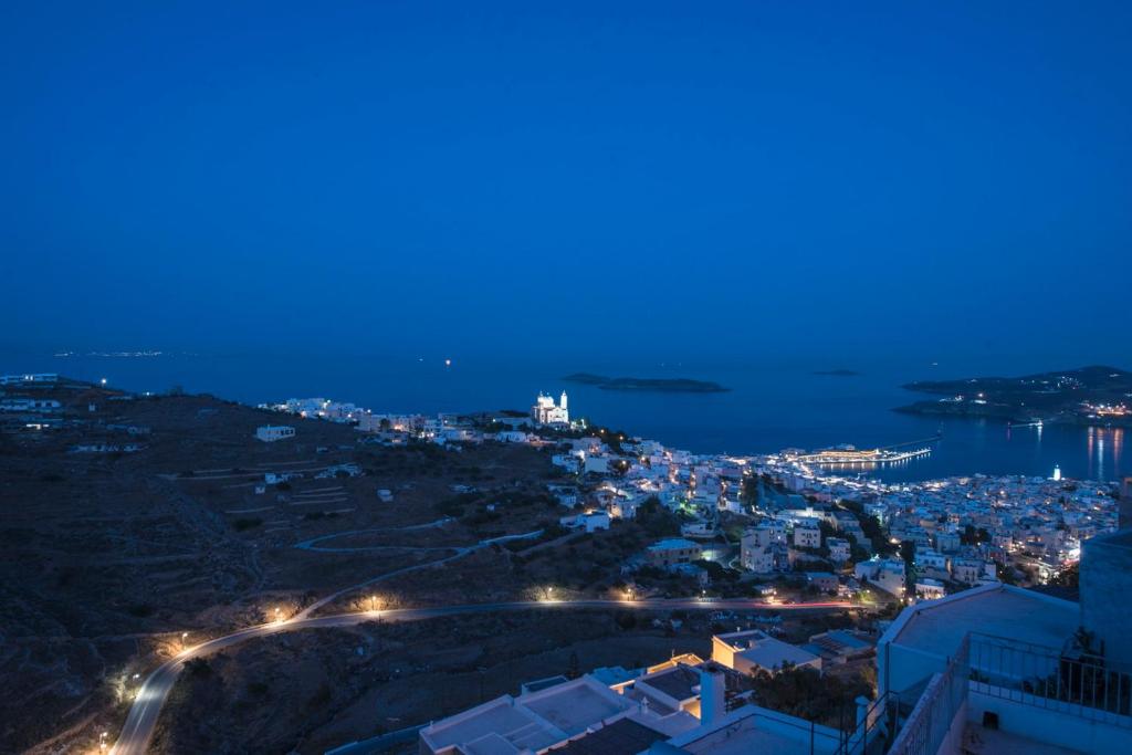 a view of a city at night with lights at Tramuntana in Ano Syros