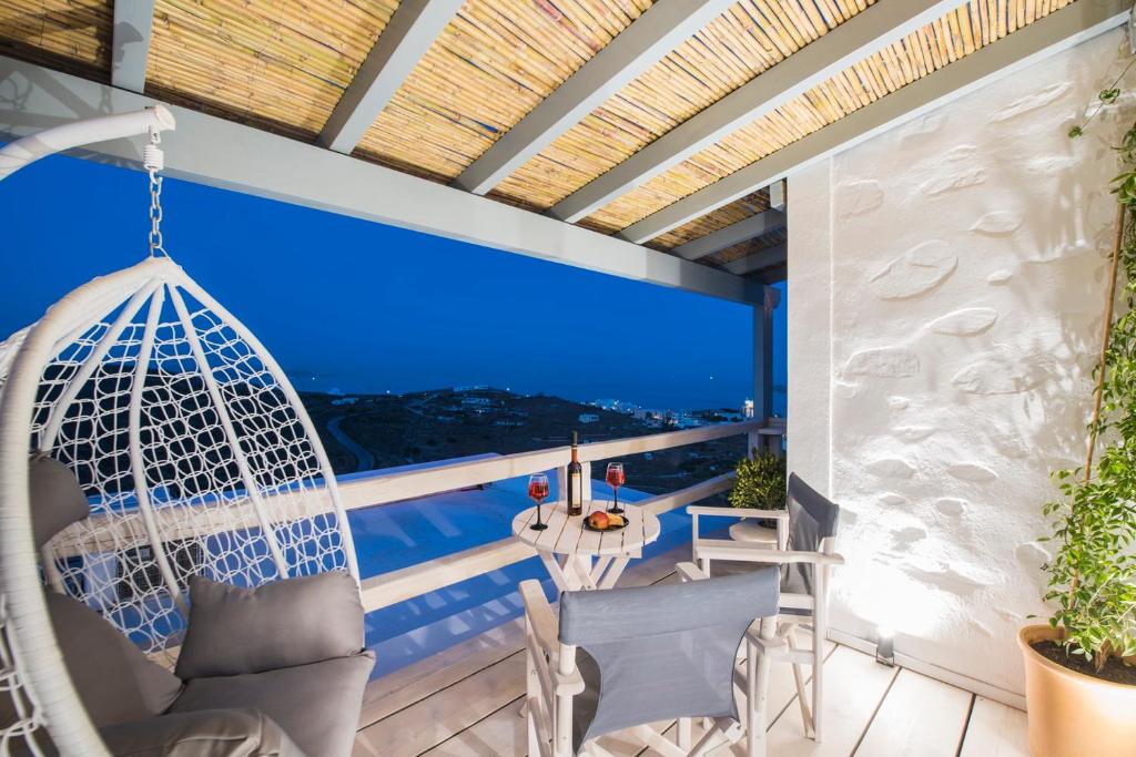 a balcony with a hammock and a view of the ocean at Tramuntana in Ano Syros