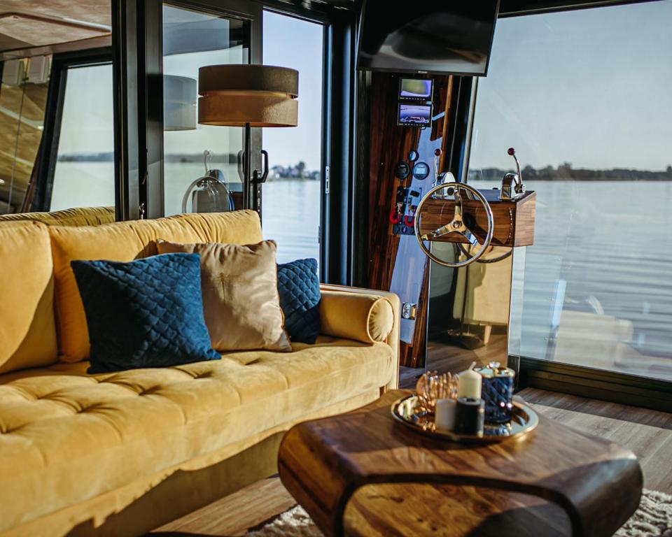a living room with a couch and a table at Hausboot mit Traumlage in Lübeck-Travemünde in Rönnau