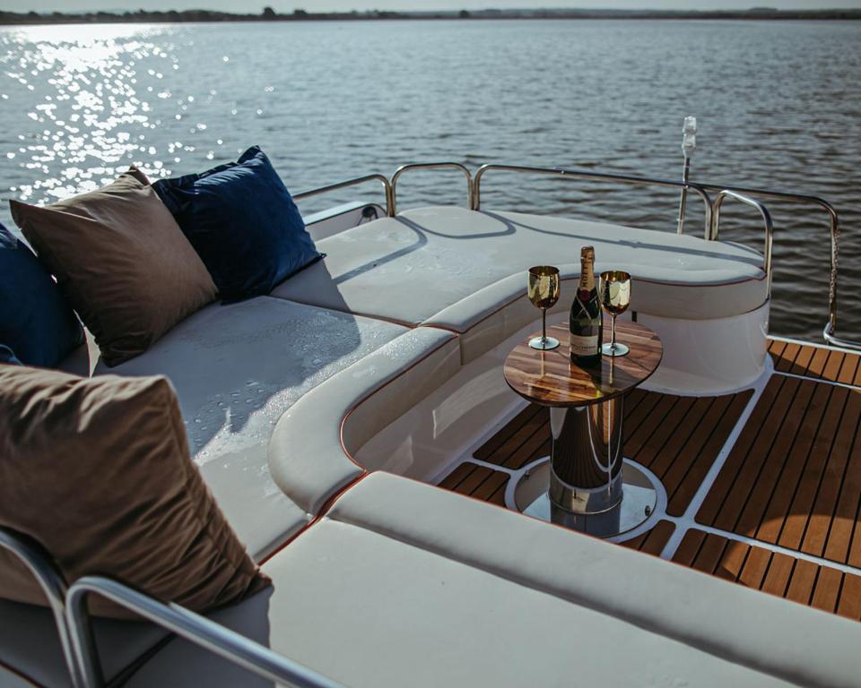 a boat with a couch and a table on the deck at Hausboot mit Traumlage in Lübeck-Travemünde in Rönnau
