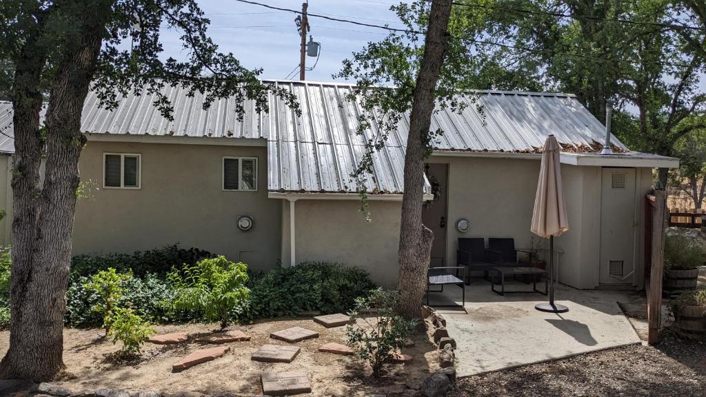 a house with an old tin roof and a patio at Mimi's Cabin in Squaw Valley