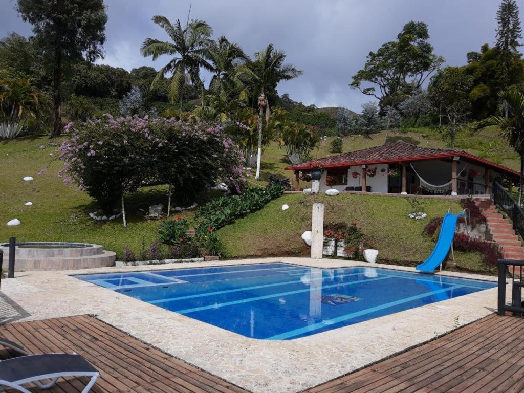a swimming pool in a yard with a house at Finca la Isabella in Fredonia