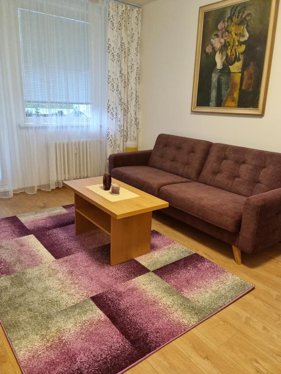a living room with a couch and a coffee table at Apartment NH12 in Bratislava