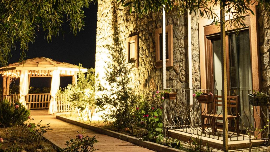 a house with a gazebo and a porch at night at Casa Di Pietra in Fethiye