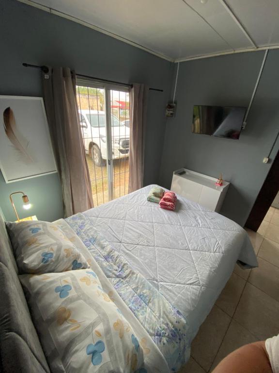 a bedroom with a bed with a blanket on it at Apartamento el uno in Chuy