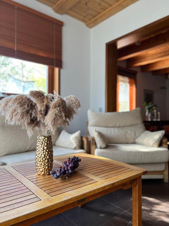 a living room with a table with a vase on it at Schneider in Pāvilosta