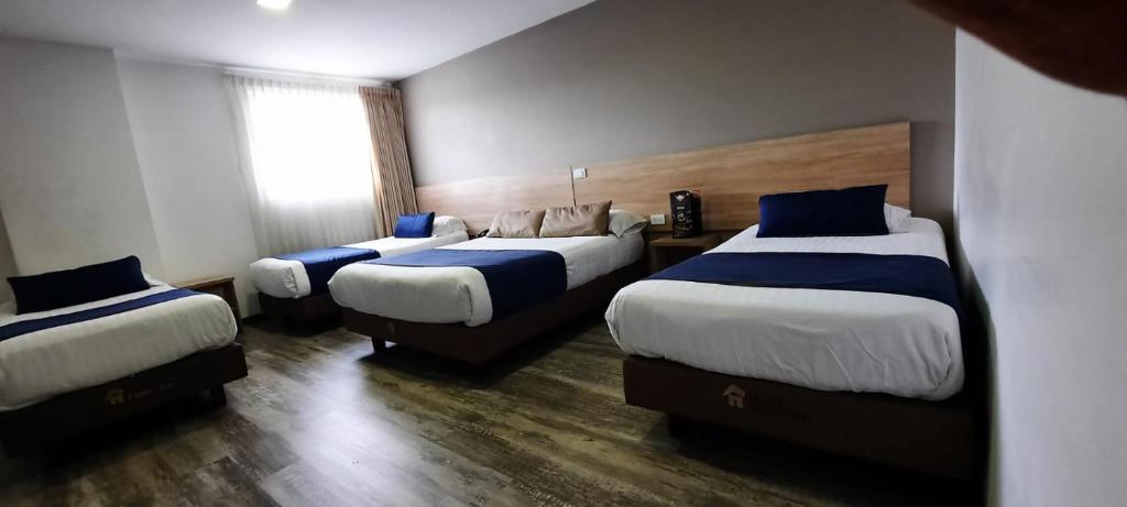Postel nebo postele na pokoji v ubytování HM HOTEL Expo Inn