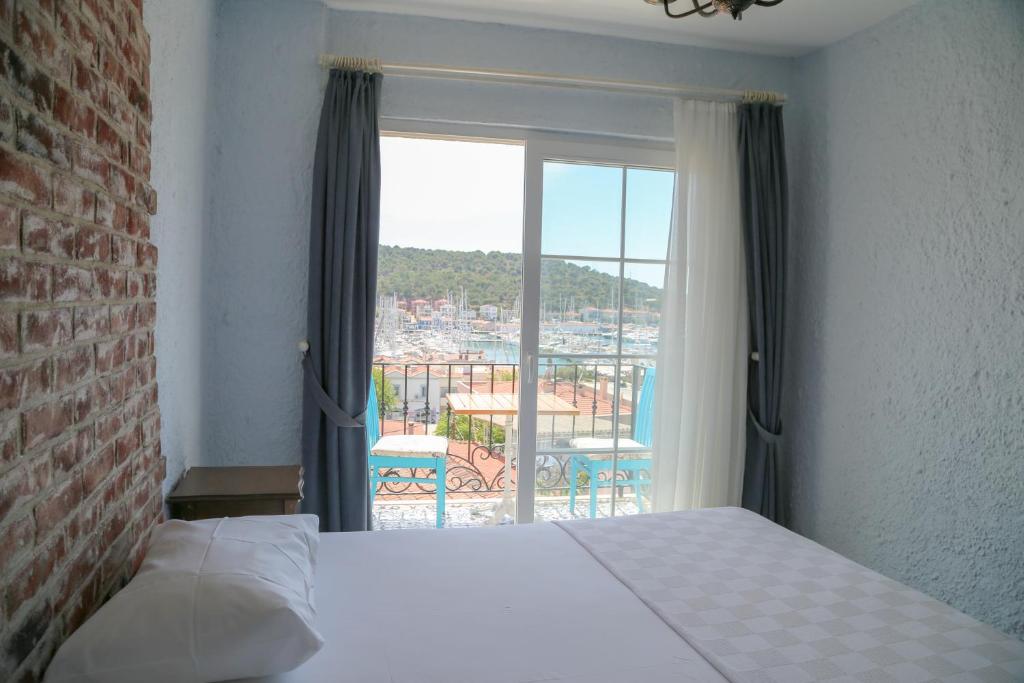 a bedroom with a bed and a large window at Villa Veria in Çeşme