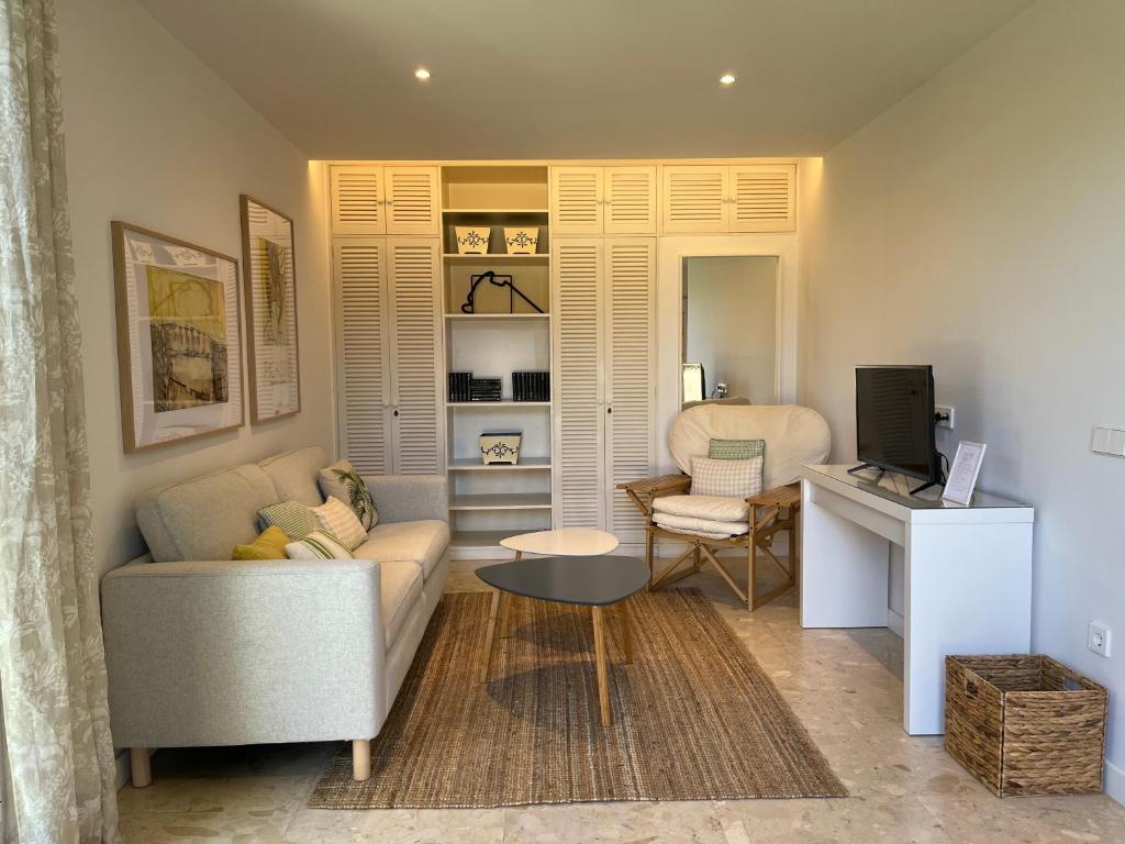 a living room with a couch and a desk at DREAM GARDEN in Santa Cruz de Tenerife