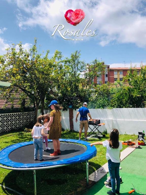 a group of people playing on a trampoline at ROSALES Apartamento y jardín in Oviedo