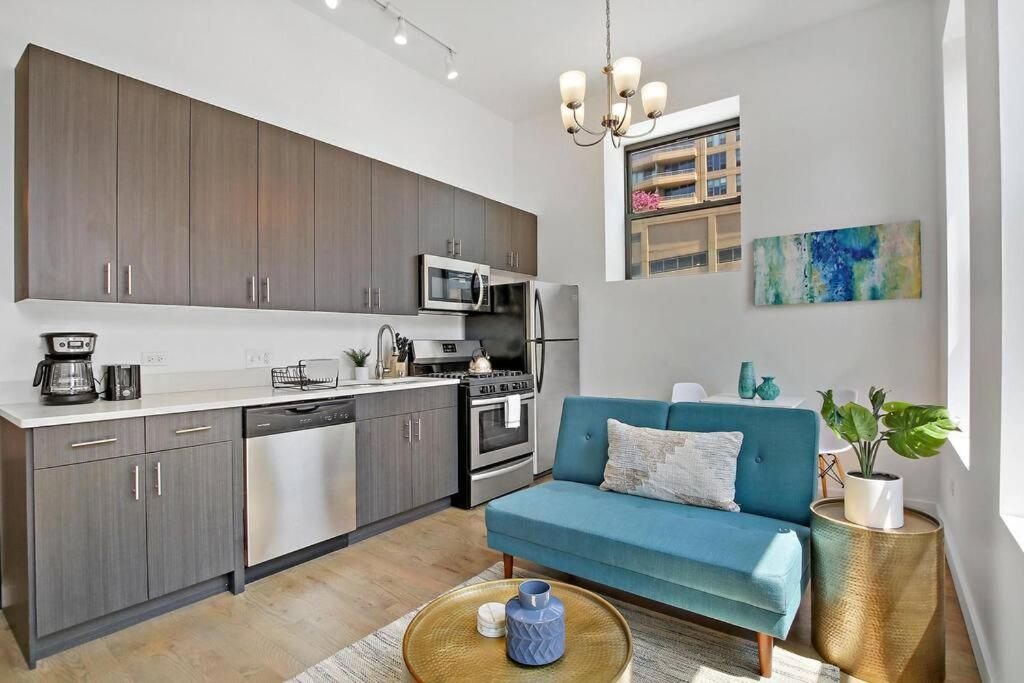 a kitchen with a blue chair and a table at Calm & Minimalist 1BR Apartment - Lake 204 in Chicago