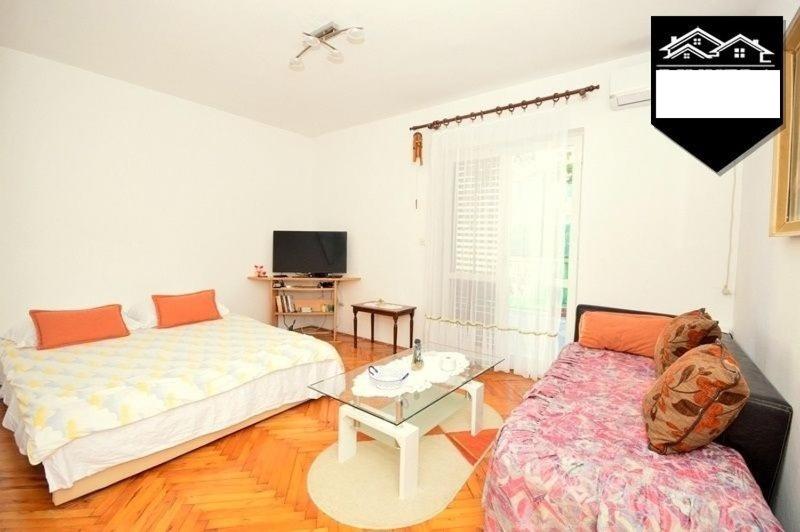 a living room with a bed and a couch at Apartment Jelka in Herceg-Novi