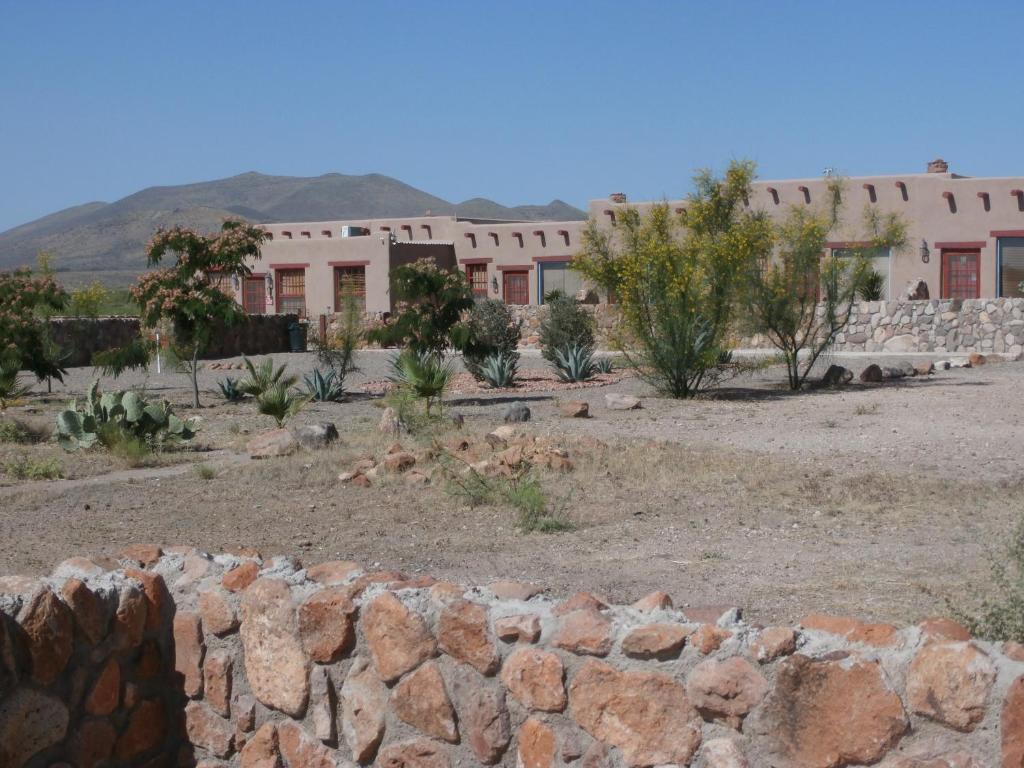 a stone wall in front of a building at PUEBLO DEL SOuL at Paquime in Casas Grandes