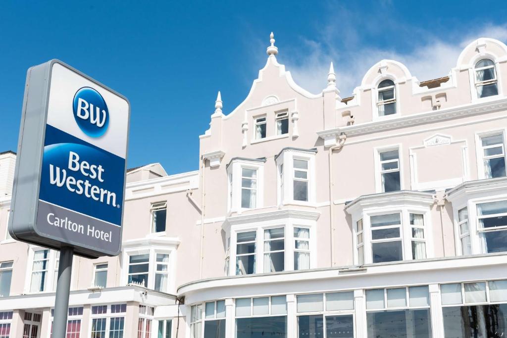 a best western sign in front of a white building at Best Western Carlton Hotel in Blackpool