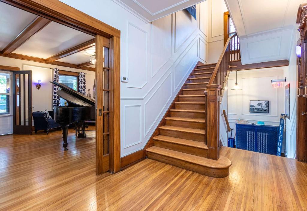 a staircase in a home with a piano at The Butler House Bed & Breakfast in Niagara Falls