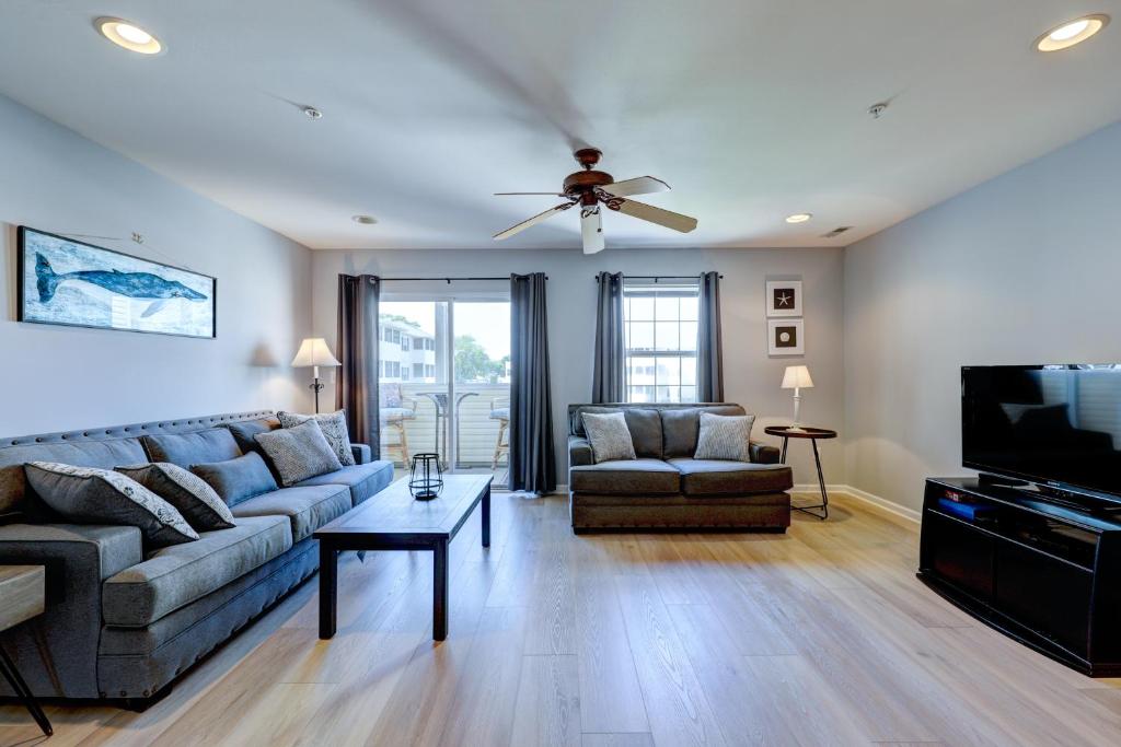 a living room with a couch and a ceiling fan at The Palms - 36525 Palm #5201 in Rehoboth Beach