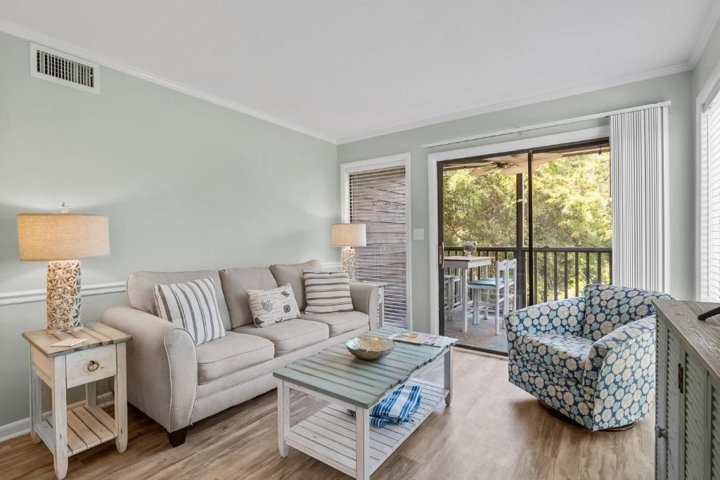 a living room with a couch and a table at Island Beach & Racquet Club H115 in Atlantic Beach