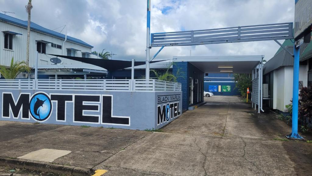 a motel sign on the side of a building at Black Marlin Motel in Innisfail