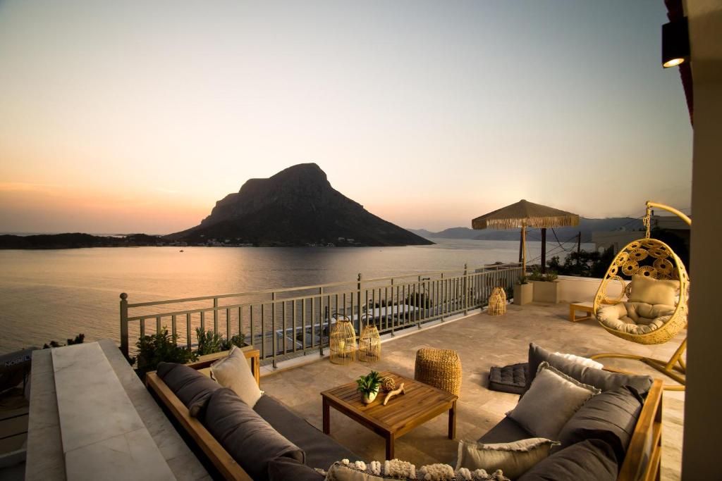a patio with couches and a view of a mountain at Horizon Hotel Kalymnos in Myrties