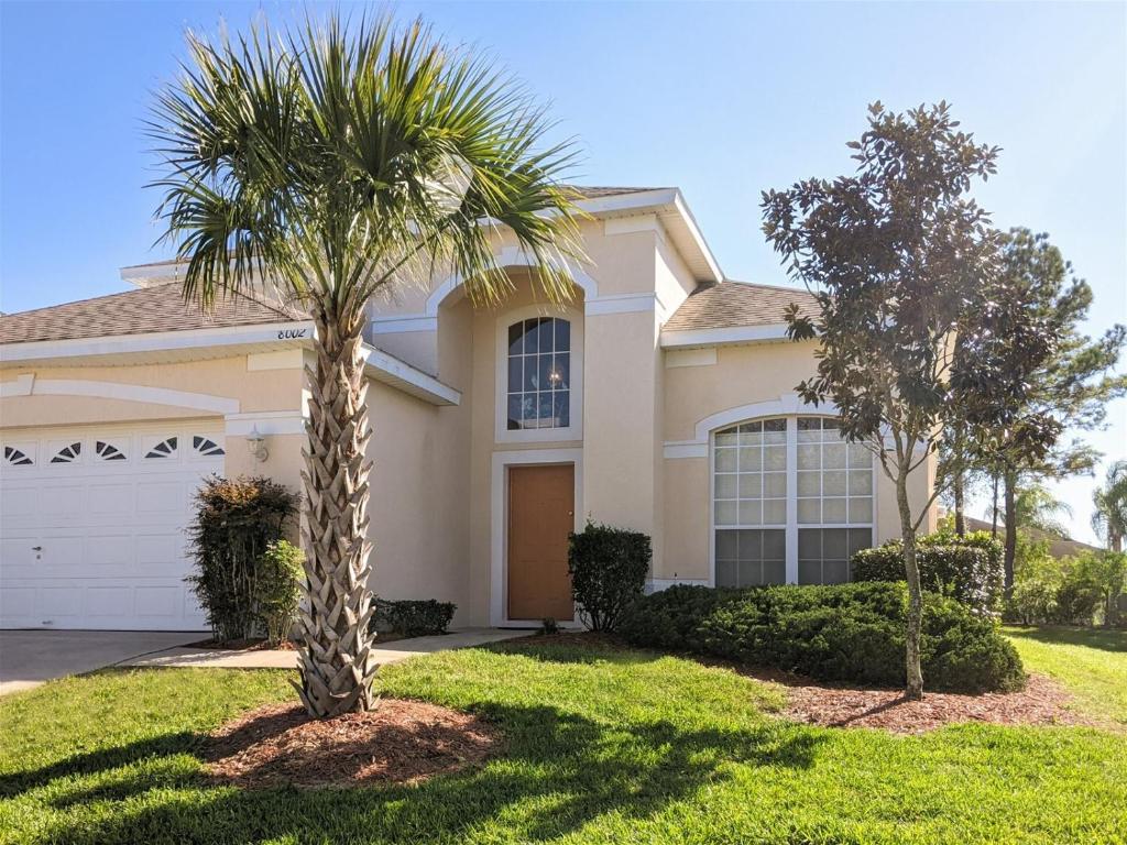 a palm tree in front of a house at 5 Bed 8002 in Kissimmee