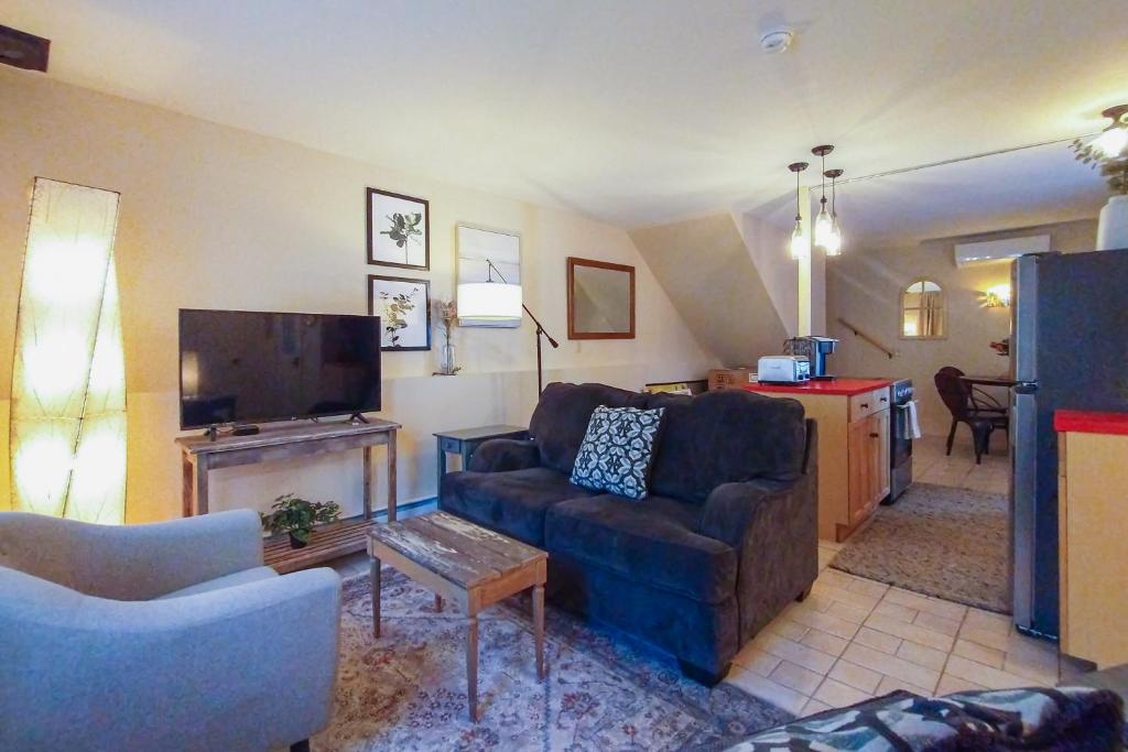 uma sala de estar com um sofá e uma televisão em A Little Mad Stay em Bar Harbor