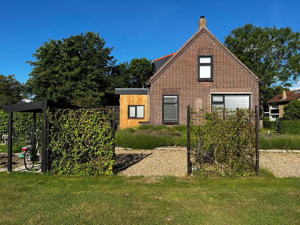 a house with a gate in front of a house at Studio49 in Ouddorp