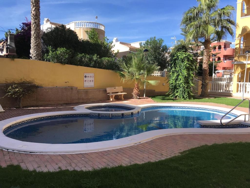 - une petite piscine dans une cour avec un bâtiment dans l'établissement Top Floor spacious apartment with roof terrace, à Alicante