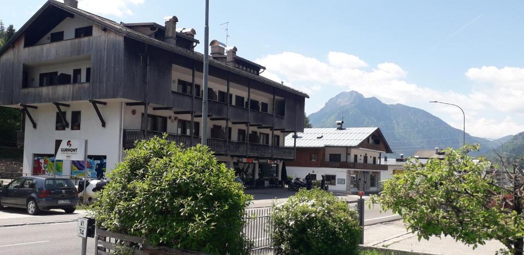 a building on a street with mountains in the background at Breakfast around the mountains in Nebbiu