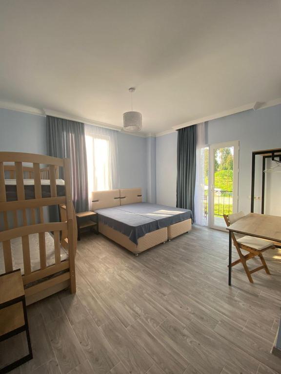 a large room with a bed and a table at KEMO house in Batumi