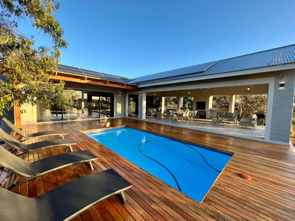 an open deck with a swimming pool on a house at Summerplace Game Reserve in Vaalwater
