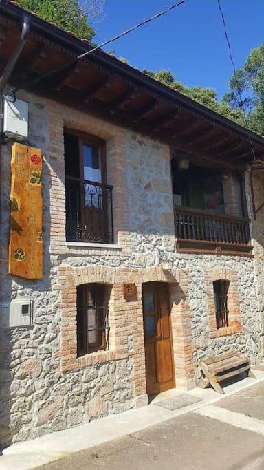 a stone building with a wooden door and windows at Casa La Cabiana in Rotella