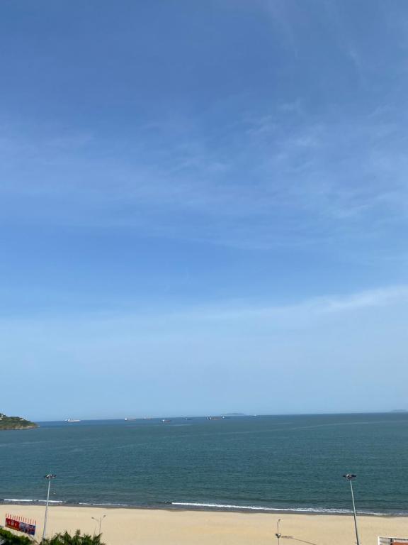 a view of the ocean from the balcony of a beach at TMS Pullman Quy Nhơn in Quy Nhon