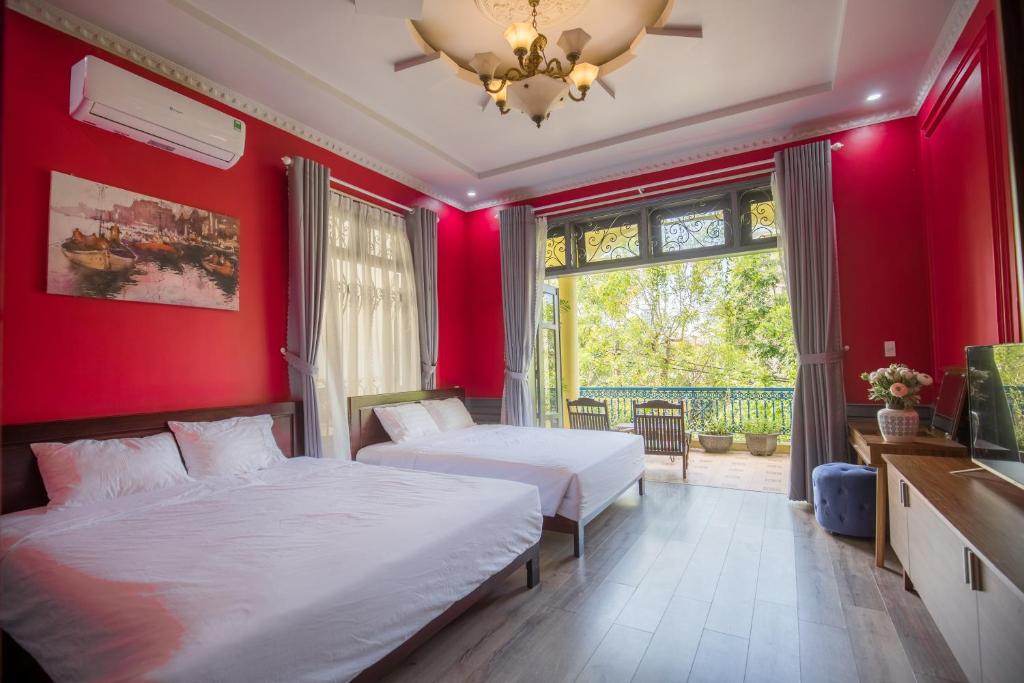 Giường trong phòng chung tại Thi Boutique Villa