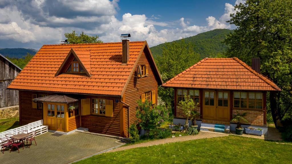 a small house with an orange roof at Holiday House Pečišće in Skrad