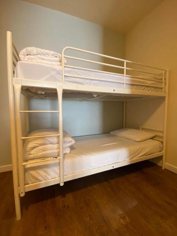 a bunk bed with white bunk beds in a room at The Anchor Hotel & Bars in Ingoldmells