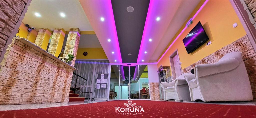 a lobby with purple lights on the ceiling at Hotel Korona in Siófok