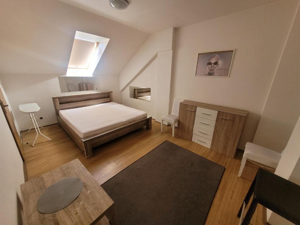 Apartments Žižkov b في براغ: غرفة نوم صغيرة مع سرير وطاولة