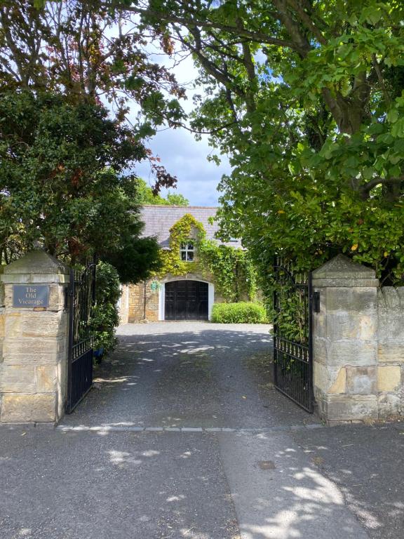 a gate to a house with a driveway at The Old Vicarage in Berwick-Upon-Tweed
