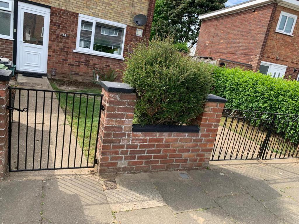 a wrought iron fence with a potted plant on it at Newly renovated 2-Bed House in Gorleston-on-Sea in Great Yarmouth