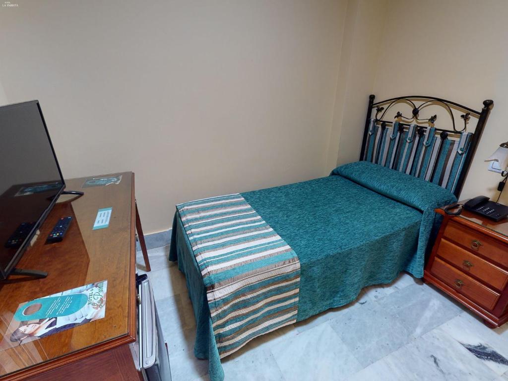 Łóżko lub łóżka w pokoju w obiekcie Hotel La Parrita