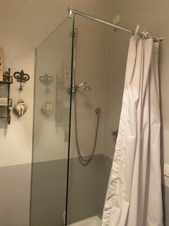 a bathroom with a shower with a shower curtain at Palazzo Nicolai in Magione